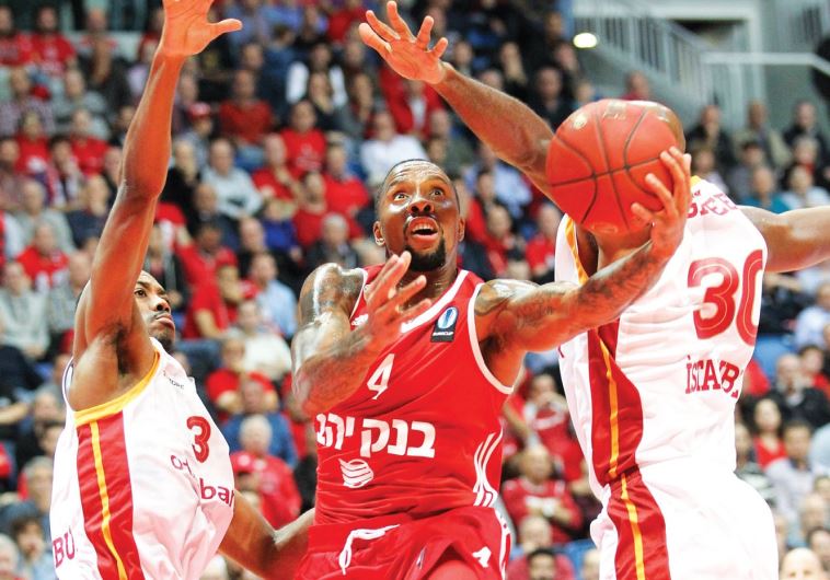 Hapoel Jerusalem guard E.J. Rowland (center)