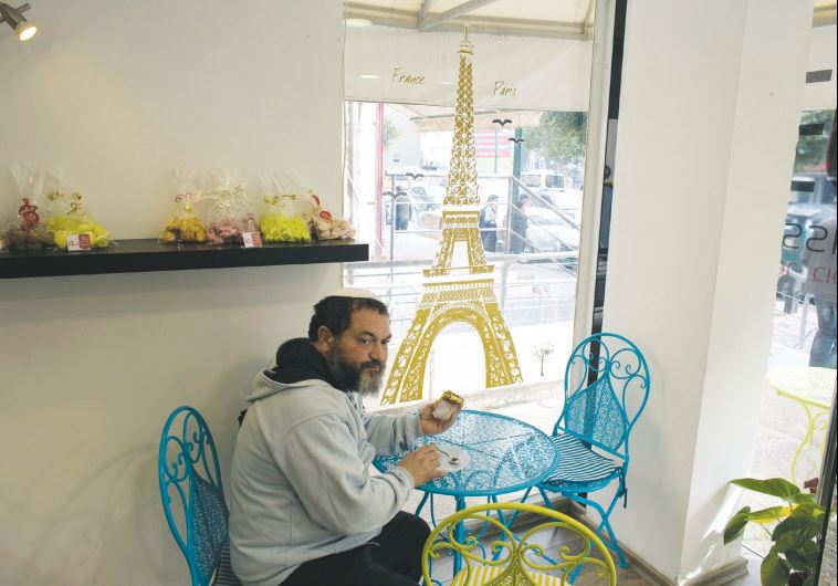 A member of the French community in Israel sits in a patisserie in Netanya, on January 25