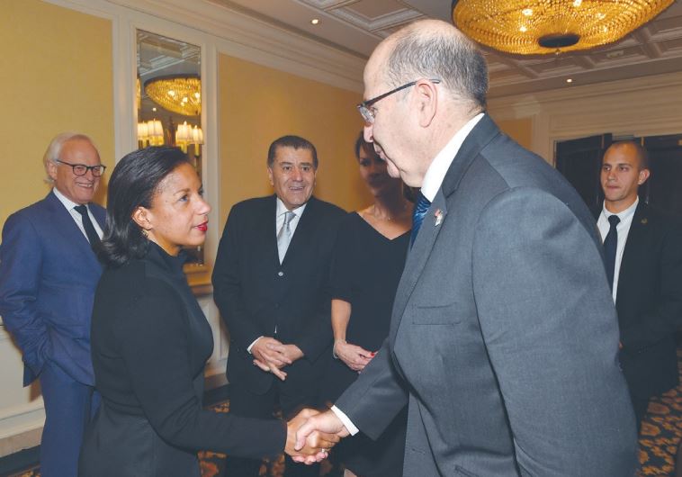 DEFENSE MINISTER Moshe Ya’alon shakes hands with US National Security Adviser Susan Rice at the Saban Forum in Washington as Haim Saban (center) looks on