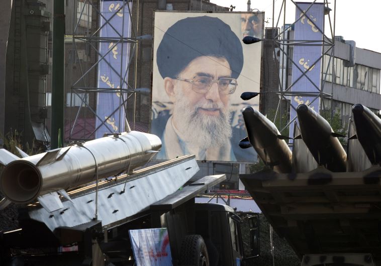 Iranian-made Fateh 110 (Conqueror) (L) and Persian Gulf (R) missiles are seen next to a portrait of Iran's Supreme Leader Ayatollah Ali Khamenei at a war exhibition in Tehran