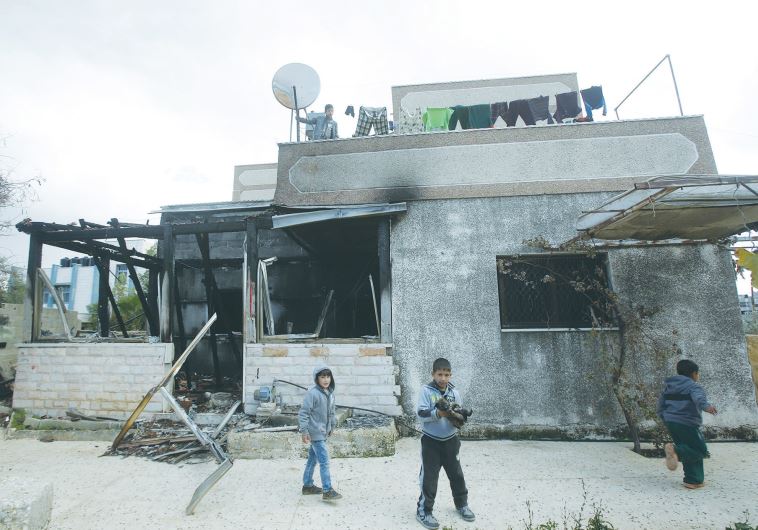 Palestinian children play in the yard of the Dawabsha family home in Duma in December, 2015