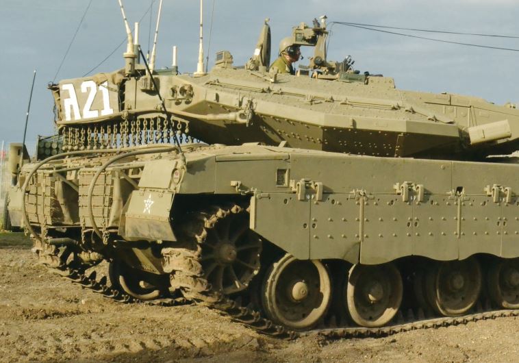 A Merkava III tank is driven by Maj. Idan Nir at the 188th Barak Armored Brigade base in the Galilee