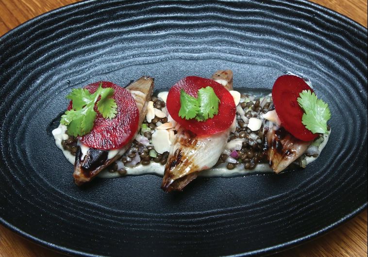 Stuffed onion with lamb, raw tehina, date honey, black lentils, celery, purple onion, cilantro and almonds