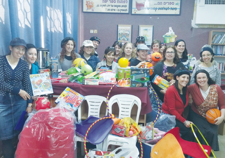 ISRAELI VOLUNTEERS display a toy-filled tranquility room they have donated to the AMIT HaRoeah elementary school in Sderot to help children there overcome trauma from rocket attacks.