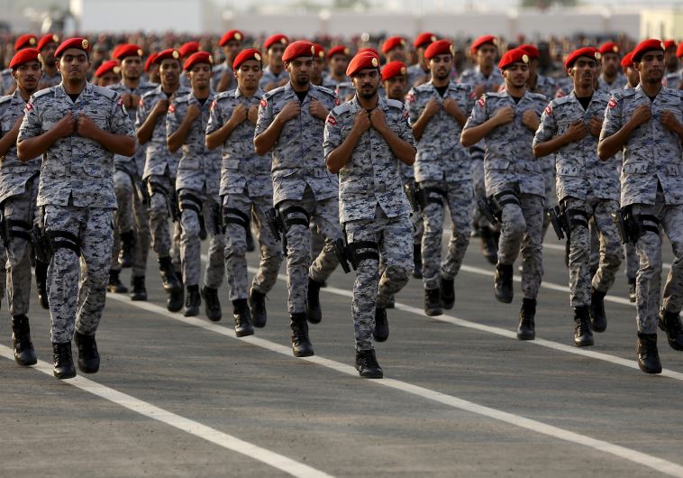 Members of Saudi security forces take part in a military parade