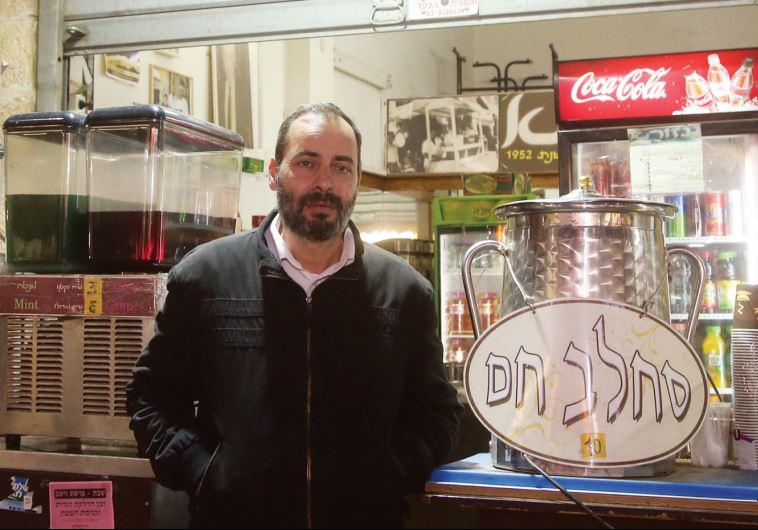 Ya’acov Nakash in front of Azura. An urn proffering hot sahlab takes a place of honor on the counter