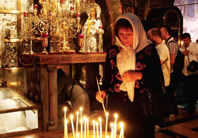 Lighting a candle at the Church of the Holy Sepulchre