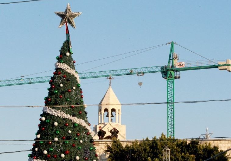 Palestinian security forces stand guard on the roof of the Church of the Nativity as Christians gather for Christmas celebrations in the West Bank city of Bethlehem