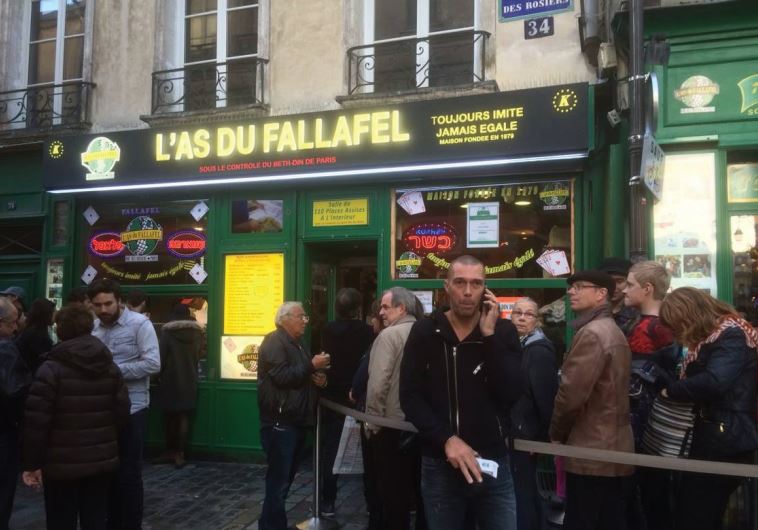 People wait in line for falafel in the Marais, the old Jewish neighborhood in Paris