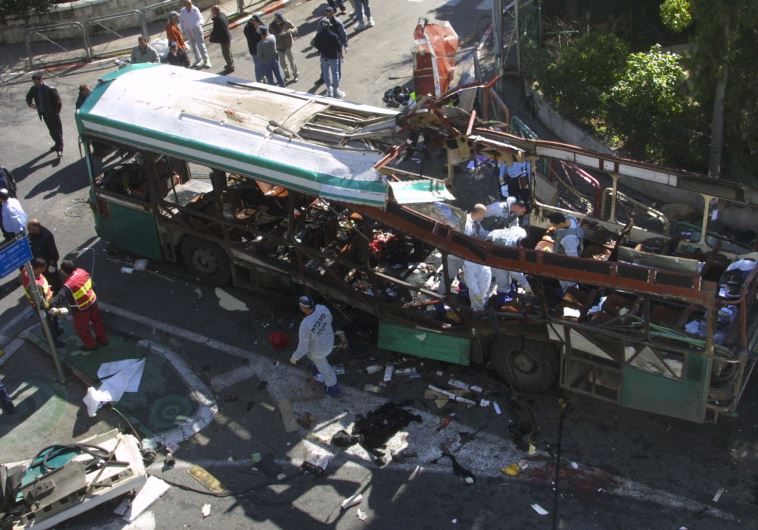 Israeli rescue workers search the wreckage of a destroyed bus following an explosion in Jerusalem January 29, 2004