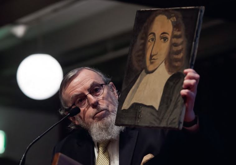 NATHAN LOPES CARDOZO holding a portrait of Spinoza that his father had painted in the time of the Holocaust