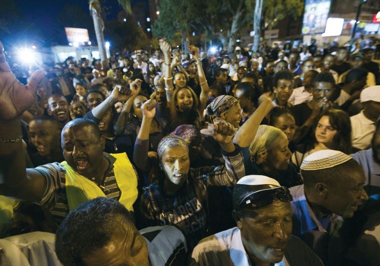 ETHIOPIAN-ISRAELIS block a road as they protest against what they say is police racism and brutality, near the southern Israeli town of Ashkelon on May 7, 2015.