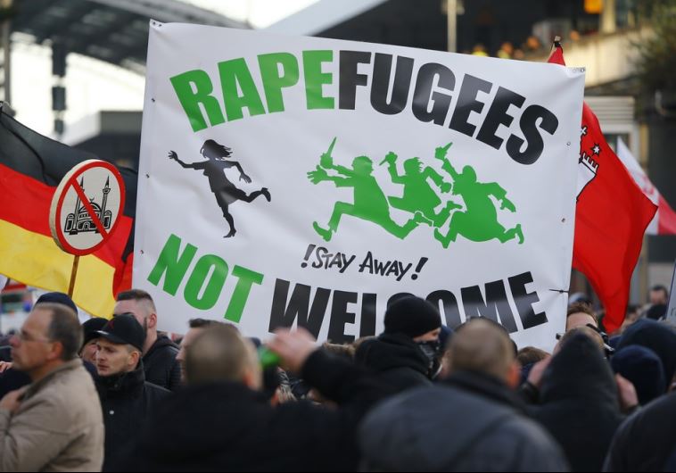 Supporters of anti-immigration right-wing movement PEGIDA (Patriotic Europeans Against the Islamization of the West) rally in Cologne