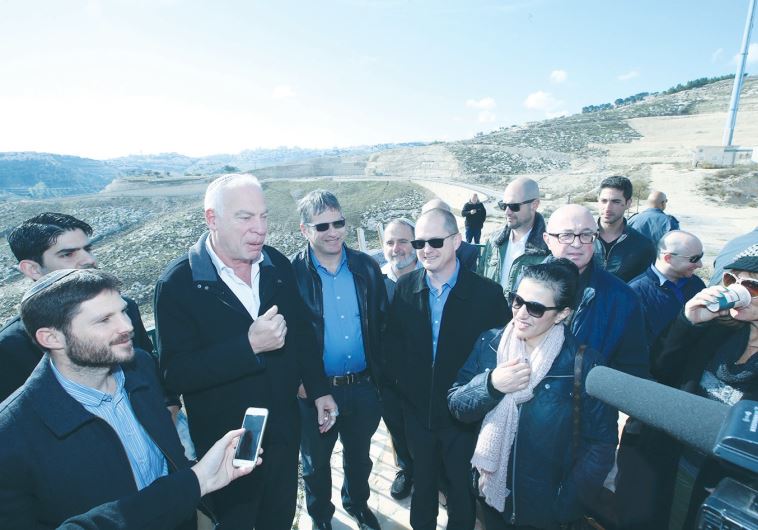 AGRICULTURE MINISTER Uri Ariel speaks at the E1 site in Ma’aleh Adumim yesterday, surrounded by members of the Knesset’s Land of Israel Caucus.
