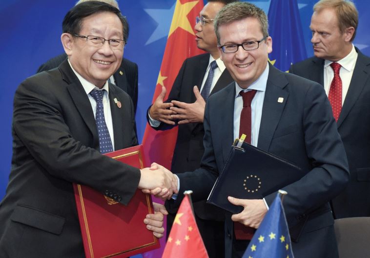 European commissioner for Research Carlos Moedas shakes hands with Xu Shaoshi, chairman of the National Development and Reform Commission during a EU-China summit last year in Brussels, Belgium