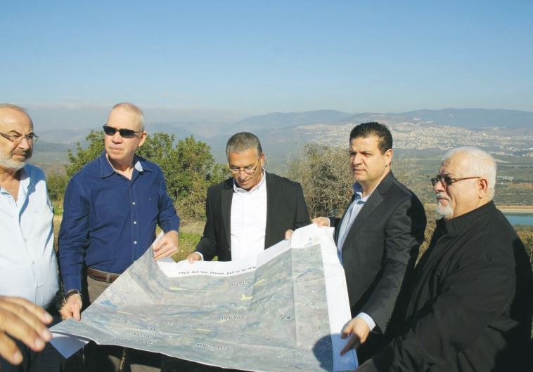 CONSTRU CTION MINISTER Yoav Galant (second from left) and Joint List leader Ayman Odeh (second from right) discuss Arab-housing development plans with leaders of the community in the North yesterday.