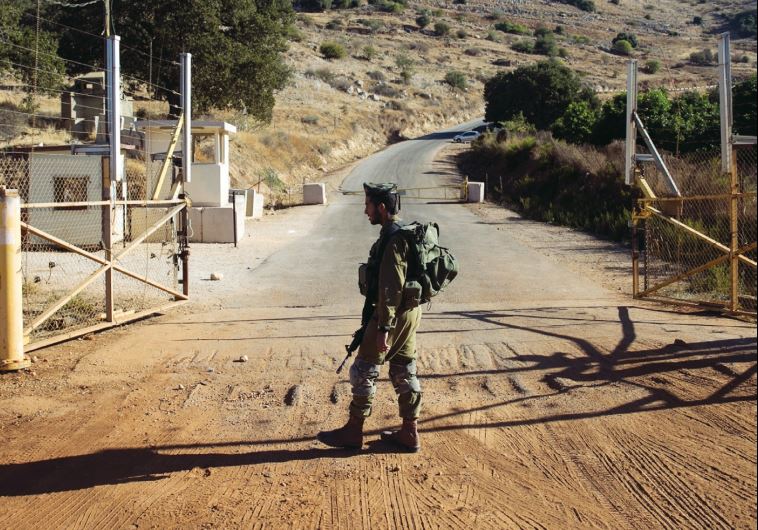An IDF soldier stands guard at a check point near the Lebanese- Israeli border, in October 2014