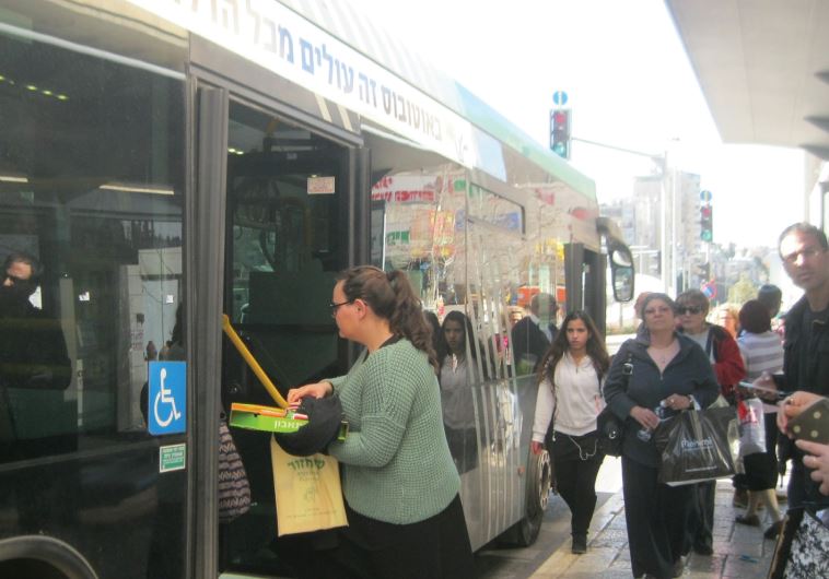 Passengers enter a bus at one of the back doors, helping to speed it on its way