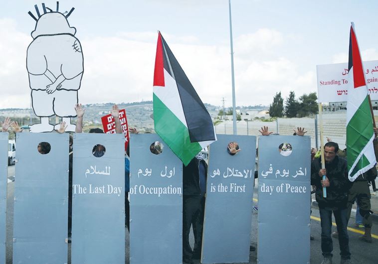 LEFT-WING Israelis and Palestinians demonstrate for a better future for both peoples near Jerusalem on Friday. The placards read: The last day of occupation is the first day of peace.