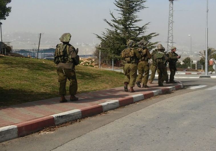 IDF forces conduct search after a Palestinian assailant stabbed an Israeli woman in Tekoa, January 18, 2016