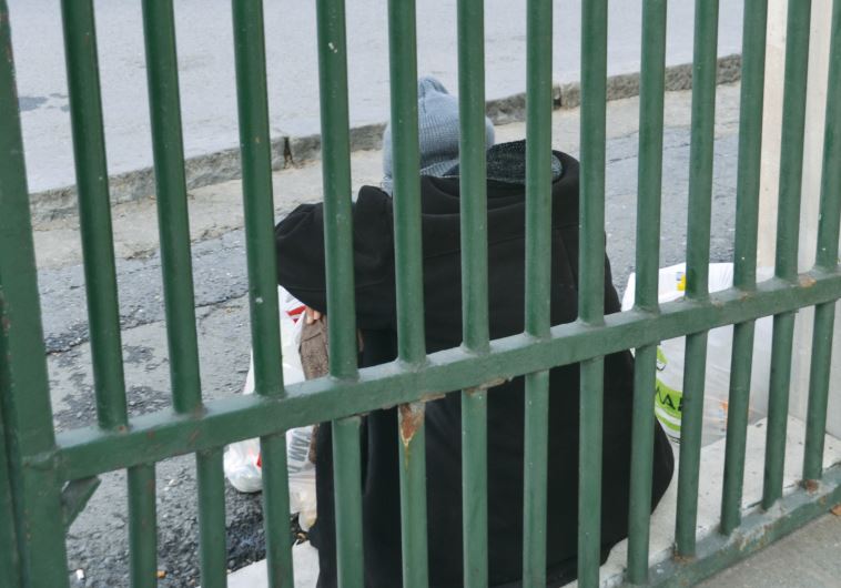 An elderly Syrian women sits outside a mosque in Suleymaniye, begging for money from passersby