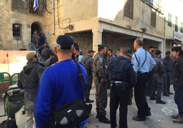 Security forces evacuate Jewish families from a building in Hebron, January 22, 2016