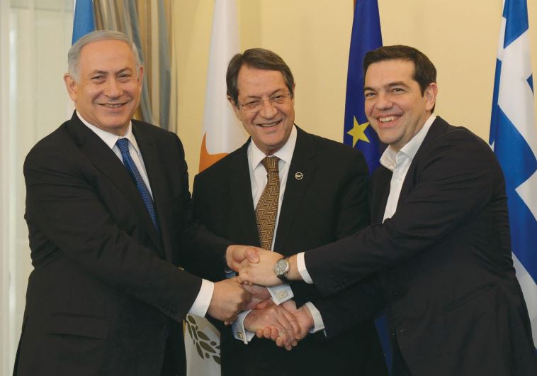 PRIME MINISTER Benjamin Netanyahu, Cypriot President Nicos Anastasiades (center) and Greek Prime Minister Alexis Tsipras shake hands ysterday outside the Presidential Palace in Nicosia, Cyprus, January 28, 2013