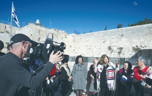 ANAT HOFFMAN (center), director of Women of the Wall, speaks to reporters at the Kotel yesterday.