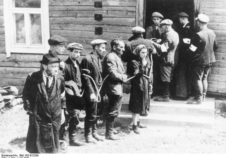 Lithuanian collaborators (with white armbands) arresting Jews in July 1941 