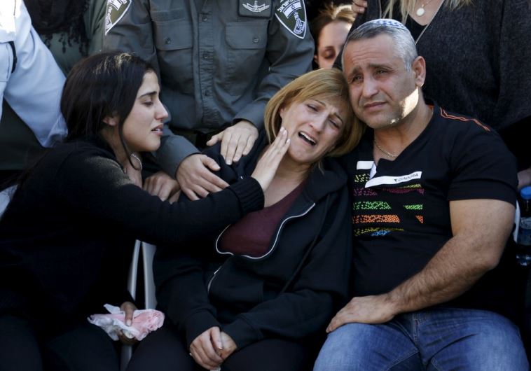 The parents of Border Policewoman, Hadar Cohen, 19, mourn during their daughter's funeral at the military cemetery in Yehud