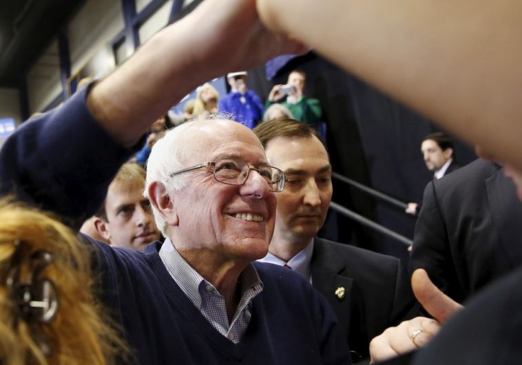Democratic US presidential candidate Bernie Sanders shakes hands with supporters during a rally in New Hampshire