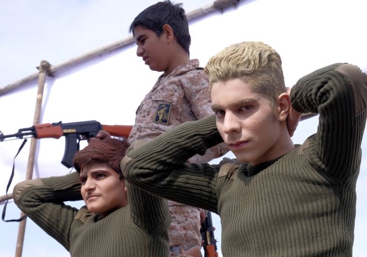 Iranian students re-enact a scene from the arrest of American sailors by Iran's Revolutionary Guard, during a ceremony marking the 37th anniversary of the Islamic Revolution, in Tehran February 11, 2016. 
