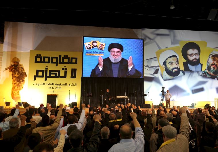 Lebanon's Hezbollah leader Sayyed Hassan Nasrallah addresses his supporters through a giant screen during a rally commemorating the annual Hezbollah Martyrs' Leader Day in Beirut's southern suburbs, Lebanon February 16, 2016