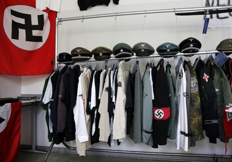 Nazi uniforms and a Swastika flag that were confiscated by the Berlin police during raids against German neo-Nazis
