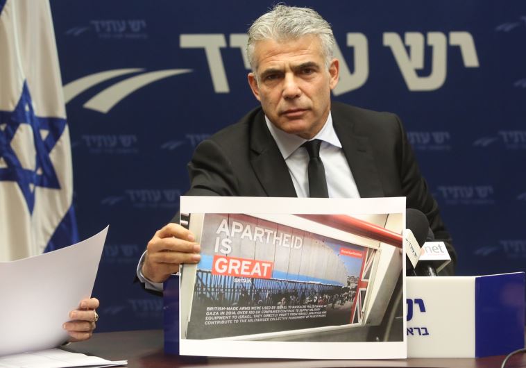 Lapid displays a picture of BDS poster 
