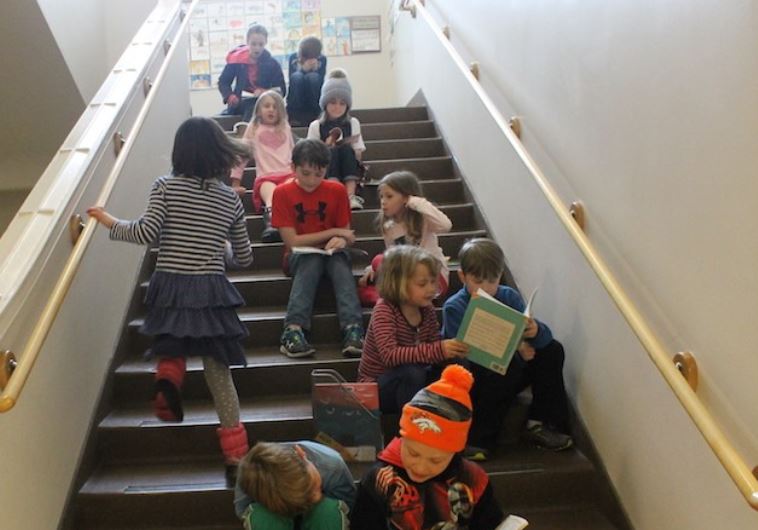 At least once a month at the McGillis School, older students take time out of the day to read stories to younger students.