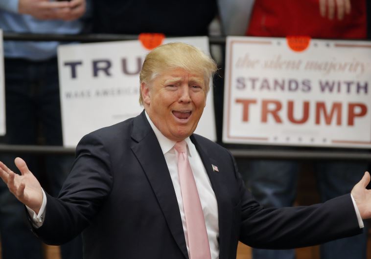 US Republican presidential candidate Donald Trump reacts to supporters as he arrives to a campaign event in Radford, Virginia