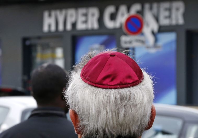 People pay tribute to the victims of a hostage taking outside the Hyper Cacher kosher supermarket near Porte de Vincennes in eastern Paris
