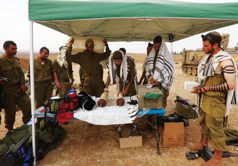 IDF soldiers pray near the Gaza border.