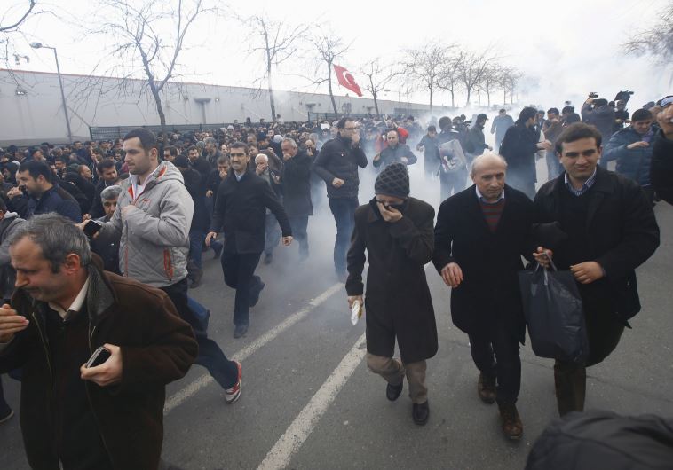 RIOT POLICE use tear gas to disperse protesting employees and supporters of the ‘Zaman’ newspaper after the mass circulation daily was nationalized earlier this month