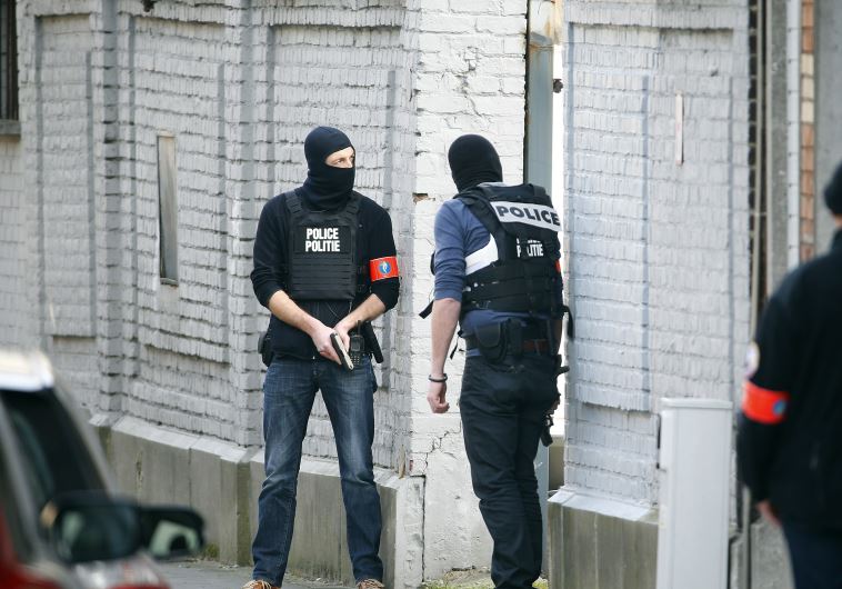 Police at the scene where shots were fired during a police search of a house in the suburb of Forest near Brussels, Belgium, March 15, 2016.
