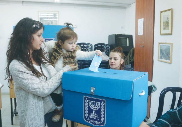 A WOMAN casts a ballot in the March 2015 national election