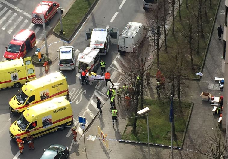 Rescue teams evacuate wounded people outside the Maalbeek metro station in Brussels on March 22, 2016 after a blast at this station located near the EU institutions