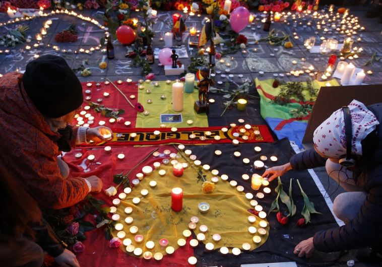 People gather around a memorial in Brussels following bomb attacks in Brussels