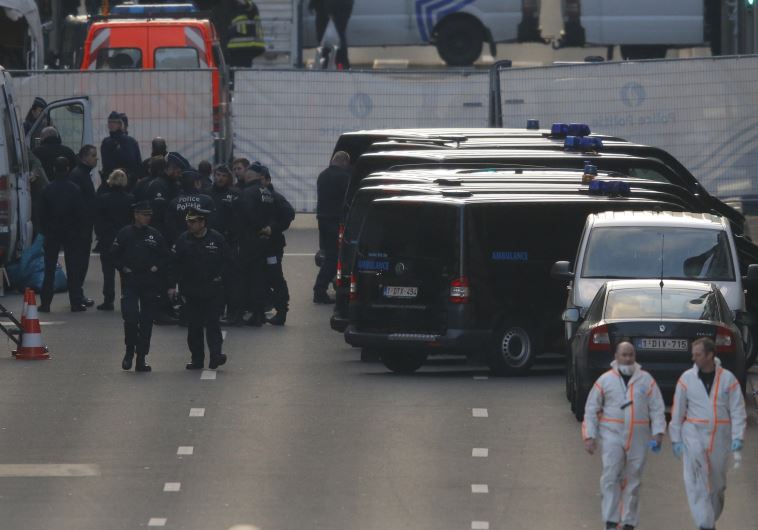 Belgian police and forensic experts work near the Maalbeek metro station following bomb attacks in Brussels, Belgium