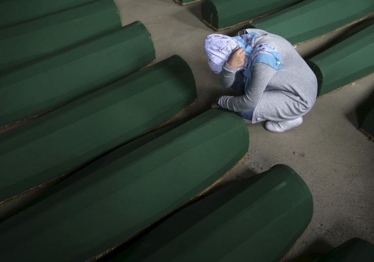 A Muslim woman cries near the coffin of her relative among the 136 newly identified victims of the 1995 Srebrenica massacre in Potocari, Bosnia and Herzegovina