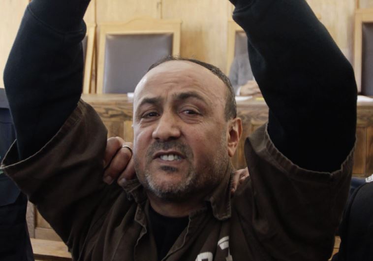 Jailed Fatah leader Marwan Barghouti gestures before a Jerusalem Magistrates’ Court hearing in 2012.