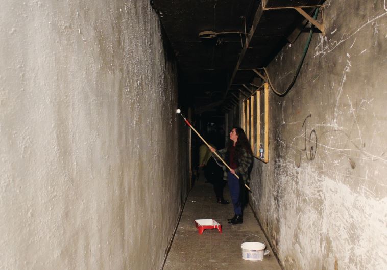 Emunah College third-year art students prepare and paint the pedestrian tunnel