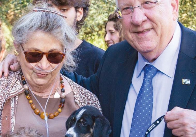 President Reuven Rivlin and his wife, Nechama, spend quality time with a puppy
