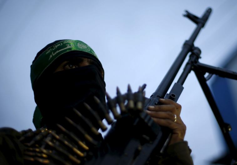 A Palestinian Hamas militant takes part in a rally marking the twelfth anniversary of the death of late Hamas leader Sheikh Ahmed Yassin in Gaza City